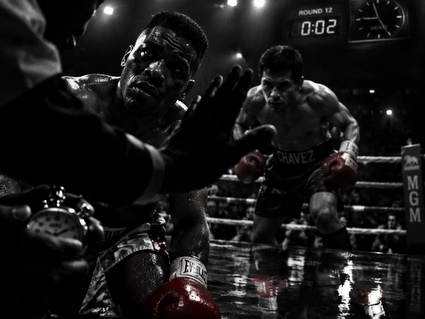 Black-and-white high-contrast image of a boxing ring in the final seconds of a fight, showing a silhouetted referee making the stop gesture, an exhausted boxer resembling Meldrick Taylor under harsh lights, and the looming figure of Julio César Chávez, all reflected in the glossy ring floor beneath a ticking clock.